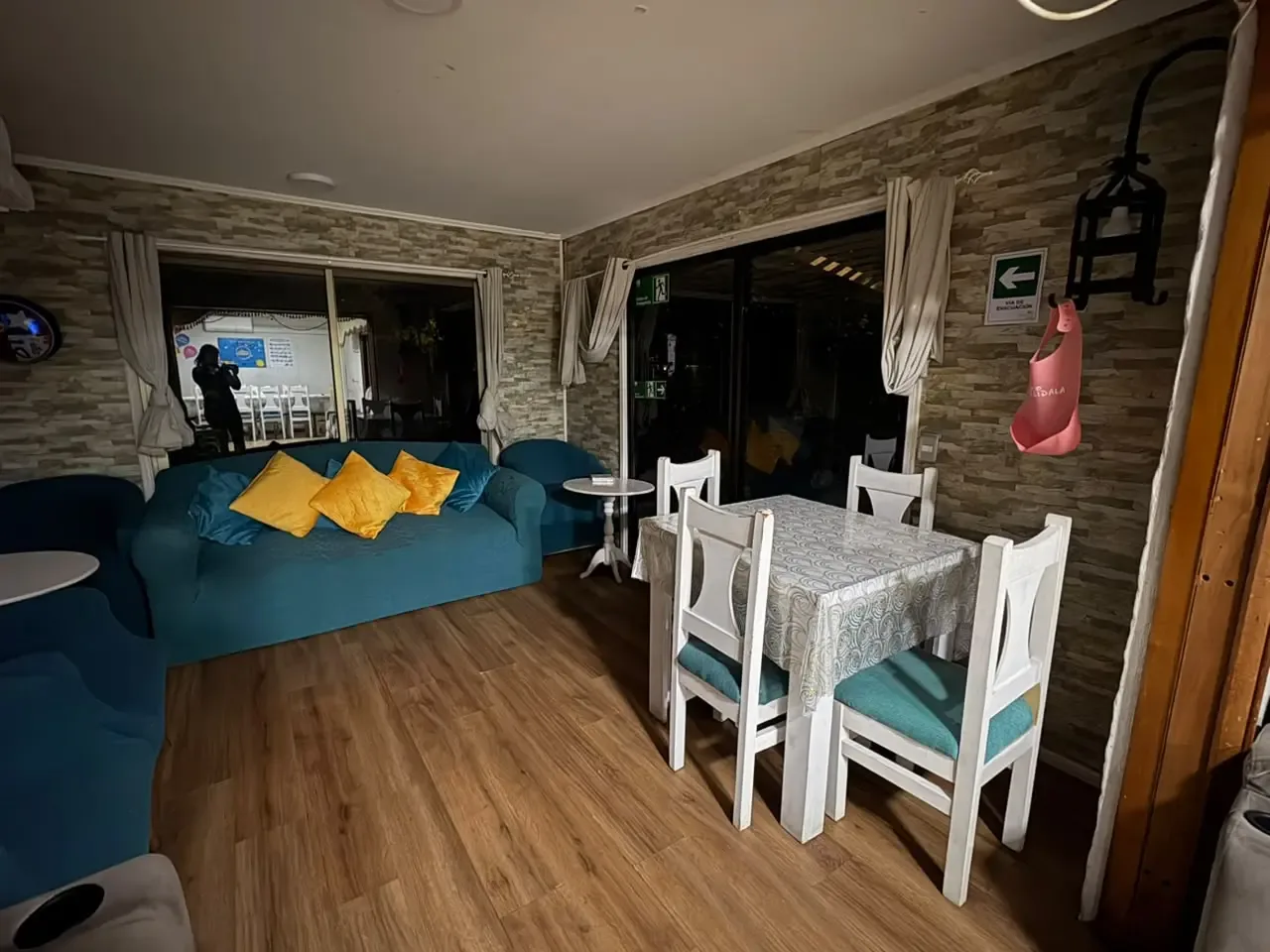 Sala de estar de Puertas de Alcalá con sillones turquesa y una mesa compartida.